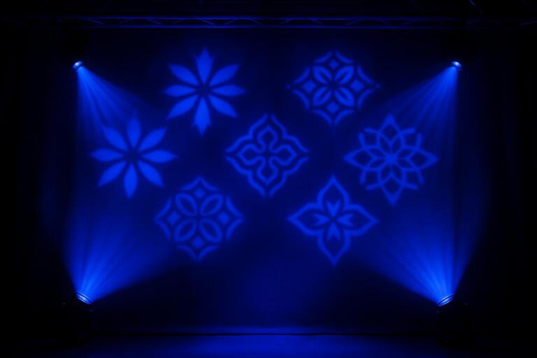 Cobalt gobo light shaping a patterned backdrop