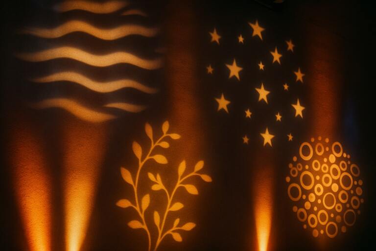 Lighting gobos casting patterned light on backdrop